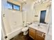 Bathroom featuring a shower-tub combo, toilet, and vanity with a mirrored backsplash at 2461 E Binner Dr, Chandler, AZ 85225