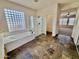 Bathroom featuring a soaking tub, glass enclosed shower, and tile floors at 2461 E Binner Dr, Chandler, AZ 85225