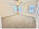Spacious bedroom featuring neutral carpeting, three windows, and a ceiling fan for optimal comfort at 2461 E Binner Dr, Chandler, AZ 85225