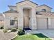 Inviting home entrance highlighted by an arched entryway and a well-manicured lawn at 2461 E Binner Dr, Chandler, AZ 85225