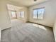 Open-concept living room with plenty of natural light and neutral carpet at 2461 E Binner Dr, Chandler, AZ 85225