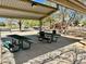 Covered picnic tables in a park with playground and shade trees under a clear blue sky at 2461 E Binner Dr, Chandler, AZ 85225