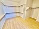 Large walk-in closet with built-in shelving and hardwood floors at 2461 E Binner Dr, Chandler, AZ 85225