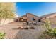 Backyard view featuring a covered patio and fire pit area with seating, ideal for relaxation at 2738 E Silversmith Trl, San Tan Valley, AZ 85143