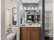 This bathroom has a light wood vanity, large mirror, and combined shower and toilet at 2738 E Silversmith Trl, San Tan Valley, AZ 85143
