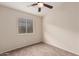 This bedroom offers a ceiling fan, natural light, and warm neutral colored walls at 2738 E Silversmith Trl, San Tan Valley, AZ 85143