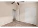 This bedroom has carpet, neutral walls, ceiling fan, and a closet with white sliding doors at 2738 E Silversmith Trl, San Tan Valley, AZ 85143