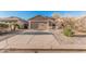 Single-story home featuring a well-maintained front yard and a spacious two-car garage at 2738 E Silversmith Trl, San Tan Valley, AZ 85143