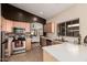 Well-equipped kitchen with stainless steel appliances, light wood cabinets, and ample counter space at 2738 E Silversmith Trl, San Tan Valley, AZ 85143