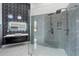 Sleek bathroom with dual shower heads, modern vanity, and unique geometric tile wall detail at 28341 N 112Th Way, Scottsdale, AZ 85262