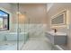 Contemporary bathroom featuring a sleek vanity, glass shower, and a soaking tub under a picturesque window at 28341 N 112Th Way, Scottsdale, AZ 85262