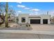 Stylish modern home with desert landscaping and two-car garage, under a partly cloudy sky at 28341 N 112Th Way, Scottsdale, AZ 85262
