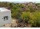 Scenic view of a modern home nestled among lush greenery, with desert landscaping and panoramic views at 28341 N 112Th Way, Scottsdale, AZ 85262