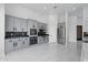 Modern kitchen with gray cabinets, stainless appliances, and marble floors at 28341 N 112Th Way, Scottsdale, AZ 85262