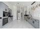 Bright kitchen with gray cabinets, stainless steel appliances, and marble floors at 28341 N 112Th Way, Scottsdale, AZ 85262