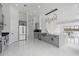 Open kitchen with gray cabinets, stainless steel appliances, and a large island at 28341 N 112Th Way, Scottsdale, AZ 85262