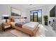 Serene main bedroom featuring a modern fireplace, plush bedding, and a picturesque view of the outdoors at 28341 N 112Th Way, Scottsdale, AZ 85262