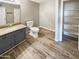 Cozy bathroom featuring single vanity with stone counter, tile floors, and a walk in closet at 3134 E Mckellips Rd # 50, Mesa, AZ 85213