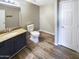 Bathroom features a vanity with a granite countertop and stylish wood-look tile flooring at 3134 E Mckellips Rd # 50, Mesa, AZ 85213