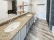 Bathroom with a dual sink vanity, modern fixtures, and stylish tile, adding a touch of luxury at 3134 E Mckellips Rd # 50, Mesa, AZ 85213