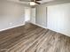 Comfortable bedroom with wood floors, a ceiling fan, and closet space for easy storage at 3134 E Mckellips Rd # 50, Mesa, AZ 85213