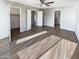 Bright bedroom featuring wood floors, ceiling fan, and ensuite bathroom for a modern comfortable living at 3134 E Mckellips Rd # 50, Mesa, AZ 85213