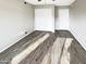 Bedroom with wood look flooring and a large closet offers ample storage at 3134 E Mckellips Rd # 50, Mesa, AZ 85213