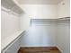 Walk-in closet with built in shelves and wood flooring at 3134 E Mckellips Rd # 50, Mesa, AZ 85213