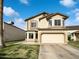 Two-story home with a two-car garage, neutral stucco, well maintained lawn, and beautiful blue skies at 3134 E Mckellips Rd # 50, Mesa, AZ 85213