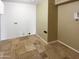 Spacious laundry room with travertine flooring and ample space for storage and appliances at 3134 E Mckellips Rd # 50, Mesa, AZ 85213