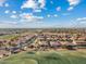 Expansive aerial view of a Primary-planned community adjacent to a well-maintained golf course at 3373 E Sports Dr, Gilbert, AZ 85298