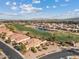 Scenic aerial view of luxury homes nestled along the golf course with a lake in the background at 3373 E Sports Dr, Gilbert, AZ 85298