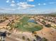 Breathtaking aerial view of homes nestled around a picturesque golf course with a serene lake at 3373 E Sports Dr, Gilbert, AZ 85298