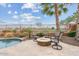 Backyard patio with a built-in fire pit, comfortable seating, desert landscaping, and golf course views at 3373 E Sports Dr, Gilbert, AZ 85298