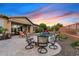 Inviting backyard with pool, spa, fire pit, and lounge chairs, perfect for outdoor relaxation at sunset at 3373 E Sports Dr, Gilbert, AZ 85298