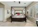 Bedroom showcases a four-poster bed, bedside tables, and large windows with plantation shutters at 3373 E Sports Dr, Gilbert, AZ 85298