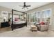 Bedroom featuring a four-poster bed, natural light from windows, and a cozy sitting area at 3373 E Sports Dr, Gilbert, AZ 85298