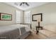 Bedroom featuring a comfortable chair, framed artwork, table lamp, and shuttered windows at 3373 E Sports Dr, Gilbert, AZ 85298