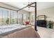 Large bedroom featuring a four poster bed, plantation shutters, and dresser with a mirror at 3373 E Sports Dr, Gilbert, AZ 85298