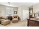 Cozy bedroom seating area with accent chair, side table, lamp, and sliding door closet at 3373 E Sports Dr, Gilbert, AZ 85298