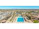 Wide aerial perspective of a community pool complex with lap pool, recreational water slide, and shaded lounge areas at 3373 E Sports Dr, Gilbert, AZ 85298