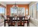 Elegant dining room with plantation shutters, a chandelier, and a view of the outdoor pool at 3373 E Sports Dr, Gilbert, AZ 85298
