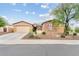 Charming single-story home with stone accents, mature landscaping, and a well-maintained front yard at 3373 E Sports Dr, Gilbert, AZ 85298
