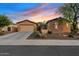 Charming home exterior featuring a spacious driveway, desert landscaping, and stone accents at 3373 E Sports Dr, Gilbert, AZ 85298