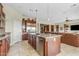 Open-concept kitchen with a central island, stainless steel appliances, and seamless flow to living area at 3373 E Sports Dr, Gilbert, AZ 85298