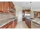 Gourmet kitchen featuring granite countertops, stainless steel appliances, and custom wood cabinetry at 3373 E Sports Dr, Gilbert, AZ 85298
