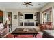Inviting living room with a ceiling fan, built-in media center, and comfortable seating arrangement at 3373 E Sports Dr, Gilbert, AZ 85298