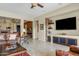 Bright and airy living room with a stone accent wall, modern entertainment center, and comfortable seating at 3373 E Sports Dr, Gilbert, AZ 85298