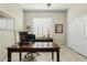 Bright home office featuring a large desk, built-in storage, and plantation shutters at 3373 E Sports Dr, Gilbert, AZ 85298