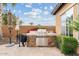This outdoor kitchen offers a built-in BBQ, stone accents, and stainless steel appliances for delightful outdoor cooking at 3373 E Sports Dr, Gilbert, AZ 85298